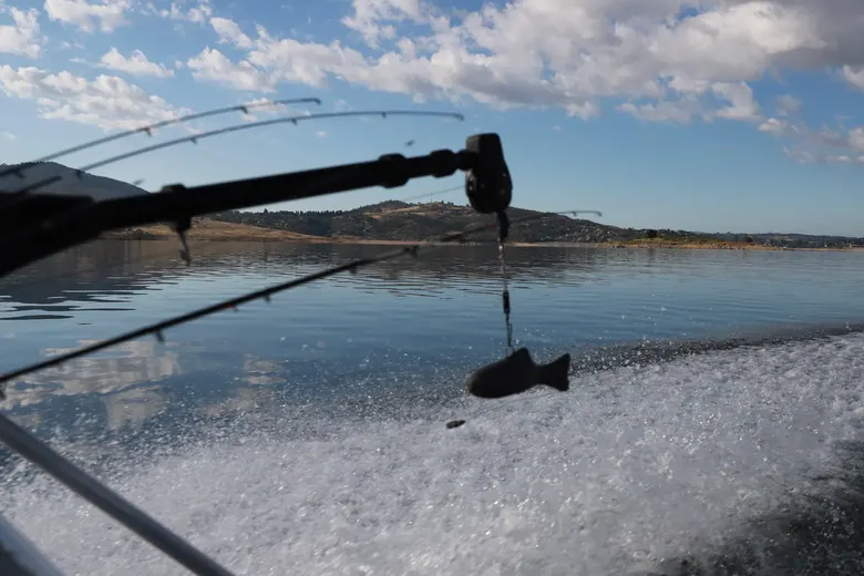 Angler hooked up, rod bent over the water